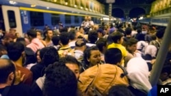 Migrants wait to board a train to Germany at the Keleti Railway Station in Budapest, Hungary, Tuesday, Sept, 1, 2015.