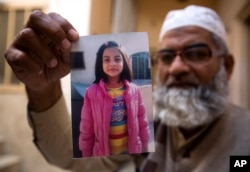 Mohammed Amin shows a picture of his daughter in Kasur, Jan. 18, 2018. Zainab was snatched in early January as she walked to a Quran class while her parents were away on pilgrimage in Saudi Arabia.