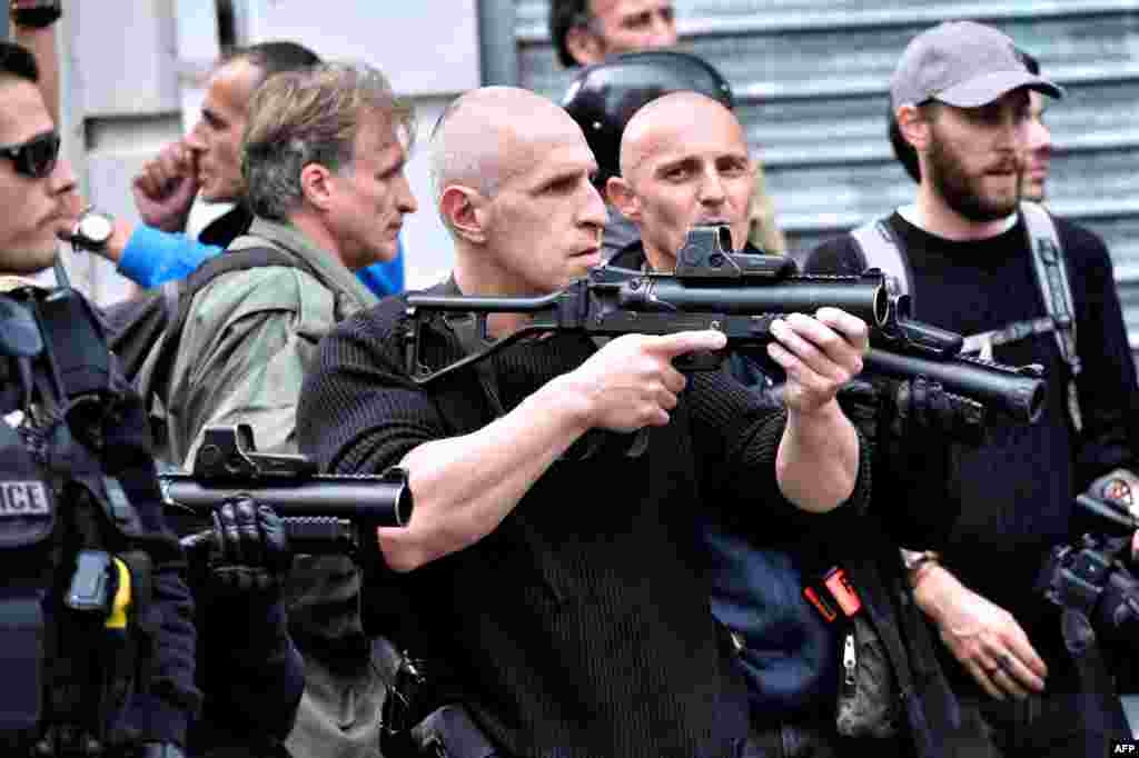 Police officers hold flash ball during clashes with England fans in central Lille on the sideline of the Euro 2016 European football championships.