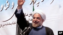 Iran's President Hassan Rouhani waves to participants while he attends a ceremony to mark the beginning of the universities academic year, at the Tehran University, in Tehran, Iran, Oct. 14, 2013. 