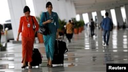 Garuda Indonesia flight attendants arrive at Terminal 3 Ultimate on the first day of its operations for domestic flights at Soekarno-Hatta Airport in Jakarta, Indonesia, Aug. 9, 2016. Female Muslim flight attendants now will have to wear headscarves on flights to Aceh.