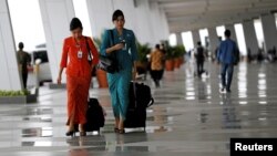  Garuda Indonesia flight attendants arrive at Terminal 3 Ultimate on the first day of its operations for domestic flights at Soekarno-Hatta Airport in Jakarta, Indonesia, Aug. 9, 2016. Female Muslim flight attendants now will have to wear headscarves on flights to and from Aceh province.
