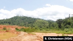 Toxic sludge split over from a dam at a small-scale mining site in southeastern Ghana, May 23, 2019.