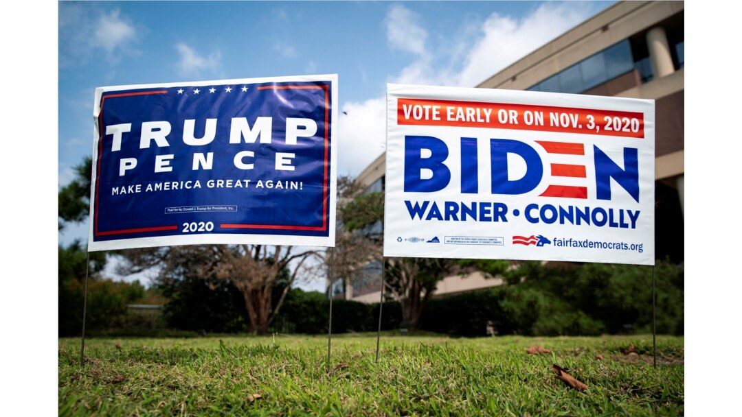 Yard signs supporting U.S. President Donald Trump and Democratic U.S. presidential nominee and former Vice President Joe Biden are seen outside of an early voting site at the Fairfax County Government Center in Fairfax, Virginia