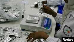 Employees inspect medication tablets produced at Azal Pharmaceutical Industries in Khartoum, (File photo).