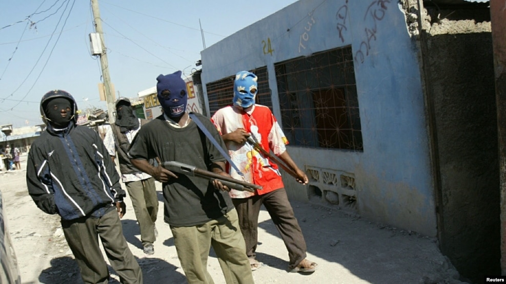 FILE - Haitian vigilante gunmen patrol their neighborhood in the Cite de Dieu (City of God) slum of Port-au-Prince, Haiti, Feb. 25, 2005.