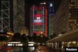 FILE - The HSBC headquarters is lit up at the Central Financial District in Hong Kong, Nov. 3, 2015.