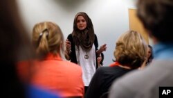 FILE - Syrian-American poet Amal Kassir recites her work during a gathering where immigrants from hostile environments spoke about their lives, at the YWCA in Boulder, Colorado, April 19, 2016.