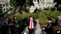 White House chief economic adviser Larry Kudlow speaks to the media after finishing interviews on the North Lawn of the White House, Aug. 16, 2018, in Washington.