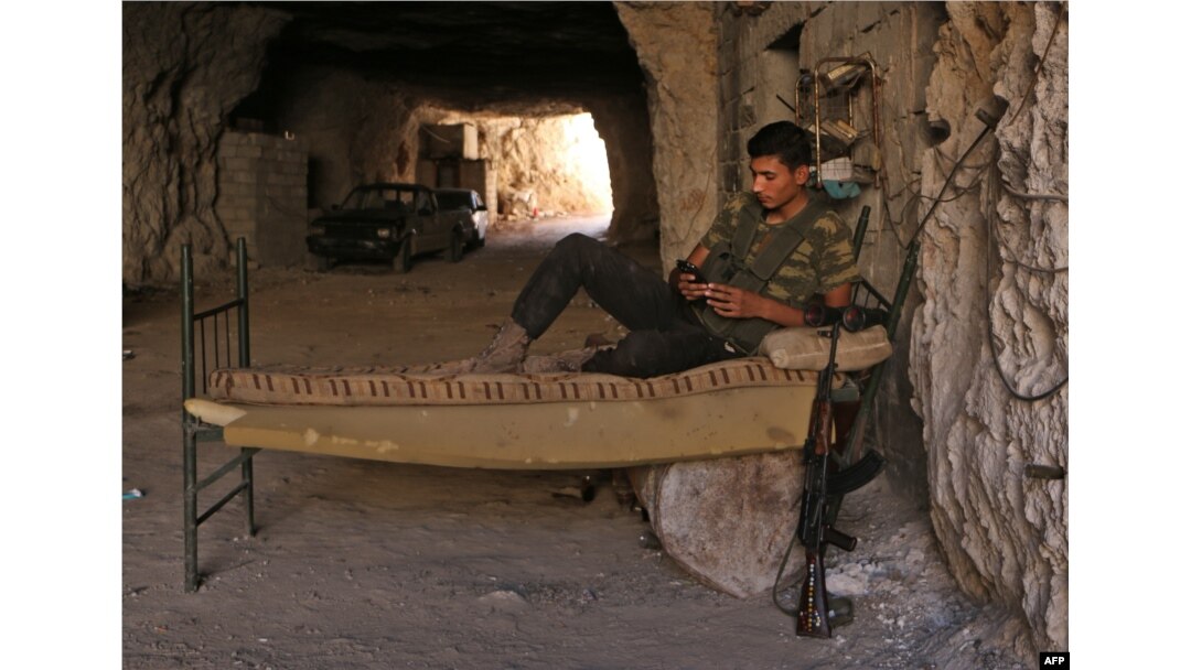 A Syrian rebel fighter rests at an unknown location in Idlib province, Sept. 5, 2018.