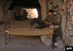 A Syrian rebel fighter rests at an unknown location in Idlib province, Sept. 5, 2018.