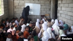 Students attend a class at the teacher's house, who turned it into a makeshift free school that hosts 700 students, in Taiz, Yemen October 18, 2018.