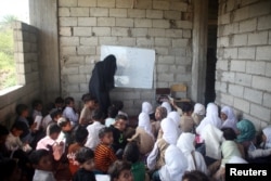 Students attend a class at the teacher's house in Taiz, Yemen, Oct. 18, 2018.