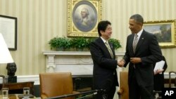 President Barack Obama shakes hands with Japan's Prime Minister Shinzo Abe at the end of their meeting in the Oval Office of the White House in Washington, Feb. 22, 2013.