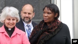 FILE - Beatrice Munyenyezi, right, leaves the federal courthouse in Concord, New Hampshire, April 12, 2012.