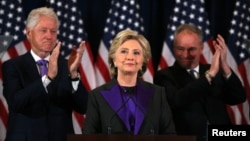 Hillary Clinton addresses her staff and supporters about the results of the U.S. election as former U.S. president Bill Clinton (L) and her running mate Tim Kaine applaud at a hotel in the Manhattan borough of New York, Nov. 9, 2016.