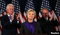 Hillary Clinton addresses her staff and supporters about the results of the U.S. election as former U.S. President Bill Clinton (L) and her running mate Tim Kaine applaud at a hotel in the Manhattan borough of New York, Nov. 9, 2016.