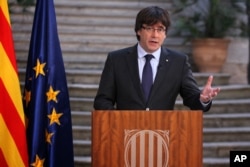 Catalan President Carles Puigdemont speaks during a statement at the Palau Generalitat in Barcelona, Spain, on Saturday, Oct. 28, 2017.
