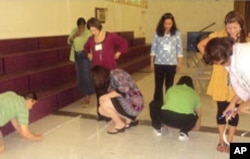 Teachers measure the distance of five steps during a Singapore Math training session.