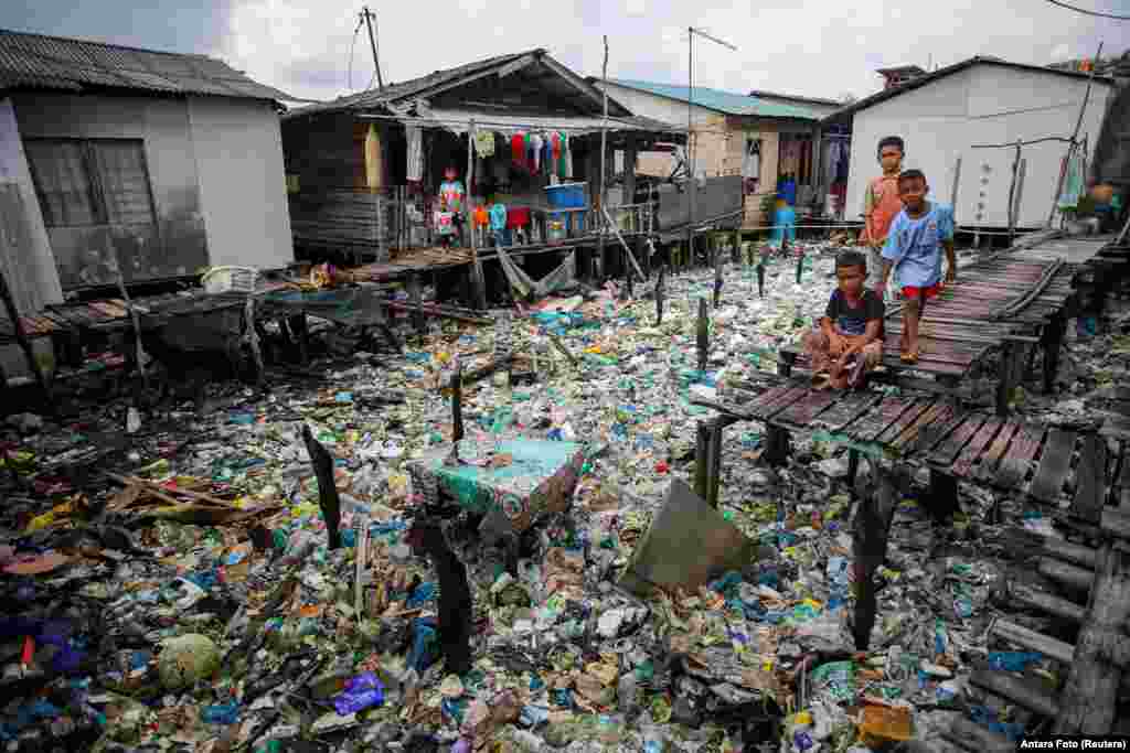 Boys are seen in the coastal settlement of Tanjung Uma, Batam, Riau Islands province, Indonesia.