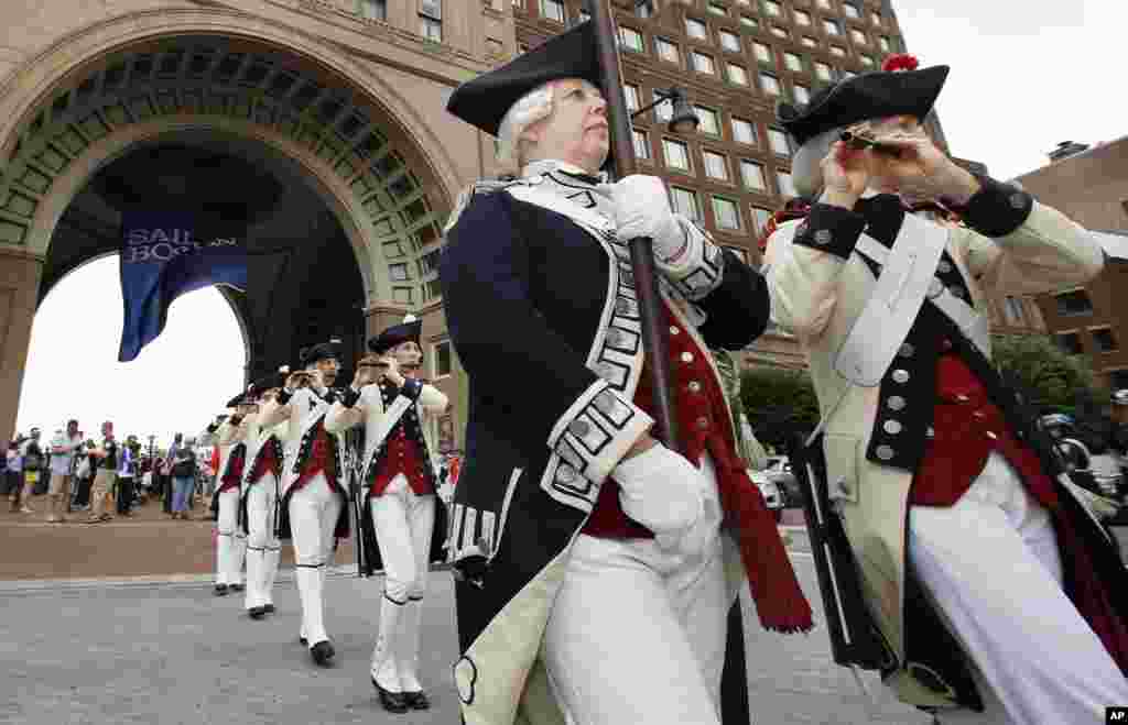 The Middlesex County Volunteers Fife and Drums march away following opening ceremonies for the Sail Boston tall ships event, in Boston, Massachusetts. The colorful procession of tall ships takes place Saturday.