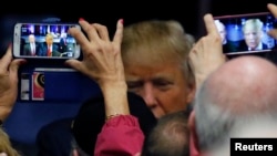 FILE - Suporters take pictures of U.S. Republican presidential candidate Donald Trump at rally in Bluffton, South Carolina, February 17, 2016.