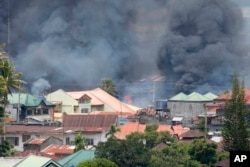 Smoke rises following airstrikes by Philippine Air Force to retake control of Marawi city, southern Philippines, May 27, 2017.