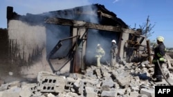 Firefighters work to extinguish a fire after shelling by pro-Russian militants on the edge of the small southern Ukrainian city of Novoazovsk, Donetsk region, Aug. 27, 2014. 