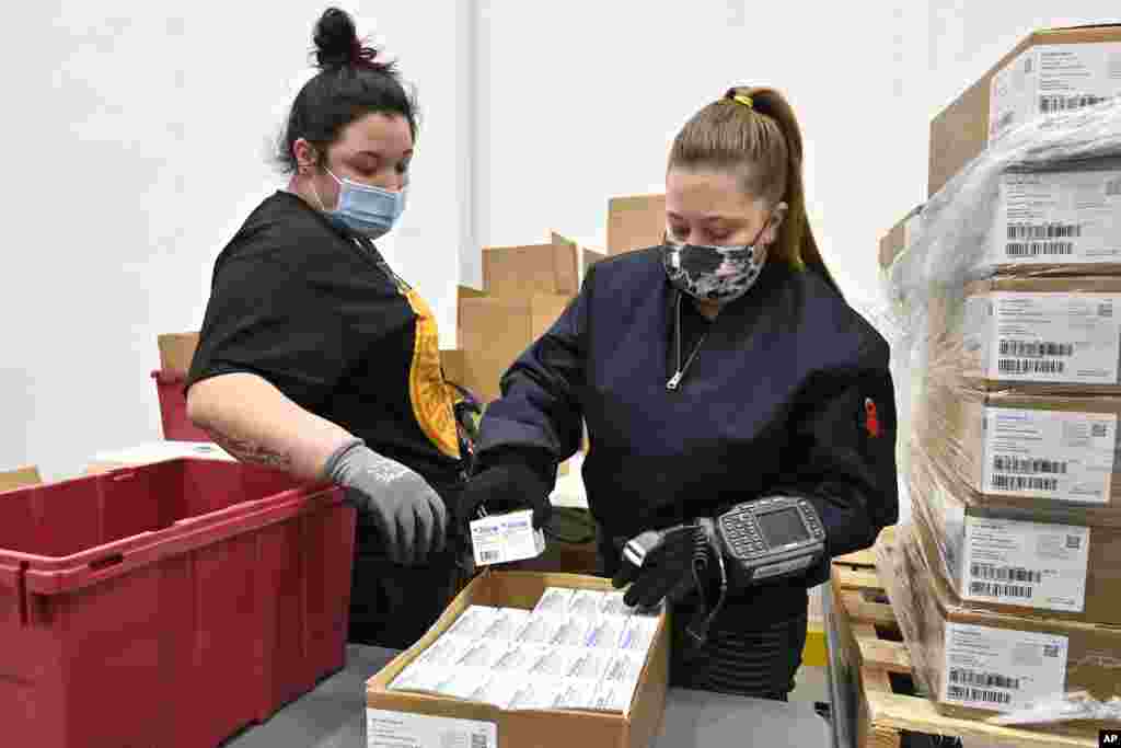 Employees with the McKesson Corporation scan a box of the Johnson &amp; Johnson COVID-19 vaccine while filling an order at their shipping facility in Shepherdsville, Kentucky.&nbsp;