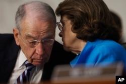 Senate Judiciary Committee Chairman Sen. Charles Grassley, R-Iowa, confers with the committee's ranking member Sen. Dianne Feinstein, D-Calif., on Capitol Hill in Washington, March 20, 2017, during the committee's confirmation hearing for Supreme Court Justice nominee Neil Gorsuch.