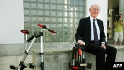 FILE - British inventor Sir Clive Sinclair poses for a photograph during the launch of his A-bike at the Design Museum in London, July 12, 2006.