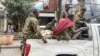 FILE - Members of the Amhara militia, that combat alongside federal and regional forces against northern region of Tigray, ride on the back of a pick up truck in the city of Gondar, on Nov. 8, 2020.