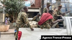 FILE: Members of the Amhara militia ride on the back of a pick up truck in the city of Gondar, on Nov. 8, 2020. Protests recently erupted in Amhara over government plans to integrate militias into the army. 