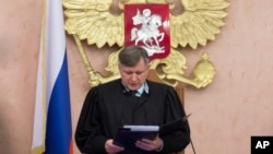 Russia's Supreme Court Judge Yuri Ivanenko reads the decision in a courtroom in Moscow, April 20, 2017, banning Jehovah's Witnesses from operating in the country. It accepted a request from the justice ministry that the religious organization be considered an extremist group. 