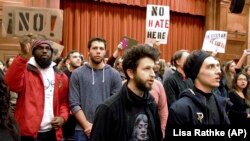 Middlebury College students turn their backs to controversial speaker Charles Murray, unseen, during his talk at the campus in 2017.