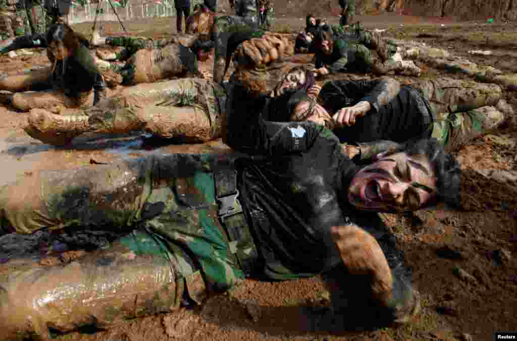 Members of Kurdish Peshmerga Special Forces demonstrate their skills during their graduation ceremony at a military camp in Soran district, in Erbil province, Iraq.