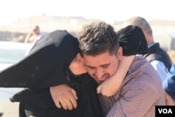 A mother weeps and hugs her son she hadn't seen in the two and a half years he has been trapped in on Nov. 3, 2016, at the Khazir camp in Kurdish Iraq. (H.Murdock/VOA)