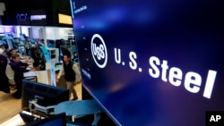 FILE - The logo for U.S. Steel appears on a screen above the trading floor of the New York Stock Exchange, in New York, Oct. 31, 2017.