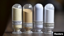 FILE - Samples of rare earth minerals from left, Cerium oxide, Bastnasite, Neodymium oxide and Lanthanum carbonate are on display during a tour of Molycorp's Mountain Pass Rare Earth facility in Mountain Pass, California, June 29, 2015. 