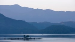 FILE - Lalu Island is seen at sunrise on Sun Moon Lake (Riyuetan Lake) in Nantou County, Feb. 20, 2008. The lake, at an altitude of 762 meters, is Taiwan's largest body of fresh water and is considered a popular tourist attraction because of its natural landscapes.