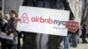 FILE- Supporters of Airbnb stand during a rally before a hearing called "Short Term Rentals: Stimulating the Economy or Destabilizing Neighborhoods?" at City Hall in New York, Jan. 20, 2015. 