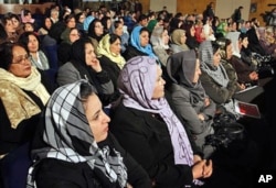 Afghan women listen to Afghan President Hamid Karzai, during a speech about women's rights, in Kabul (File)