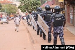 FILE - Anti-riot police walk the streets of Kampala, Uganda, Sept. 21, 2017, searching for protesters against the lifting the constitutional age limit for presidents.