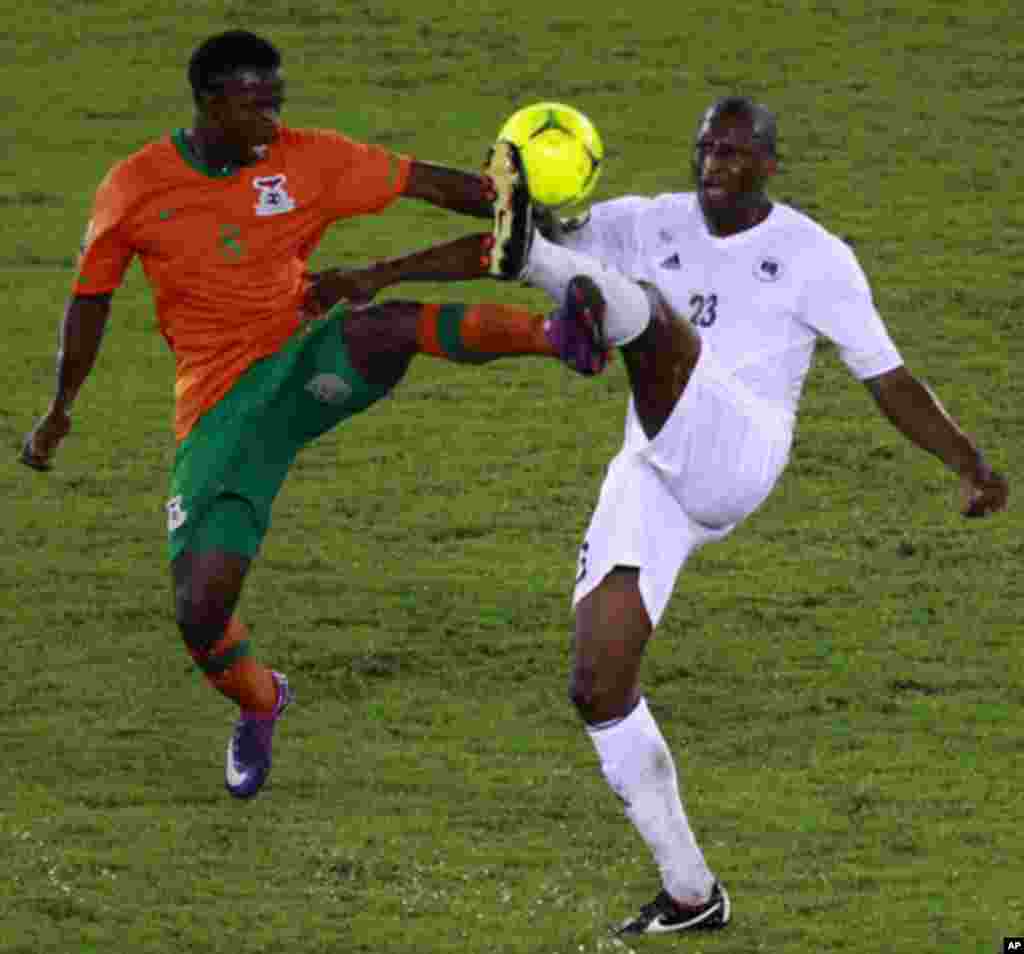Stophira Sunzu of Zambia (L) challenges Ahmed Zuway of Libya during their African Nations Cup Group A soccer match at Bata Stadium in Bata