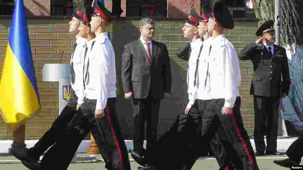 Ukrainian President Petro Poroshenko watches cadets as they march during Knowledge Day celebrations in Kyiv, Sept. 1, 2014. 