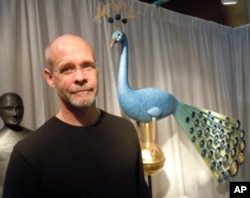 Sculptor Mark Perry sells works such as his hand-carved peacock for $25,000.