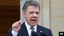 FILE - Colombia's President Juan Manuel Santos speaks to the media at the presidential palace in Bogota, April 17, 2015. 