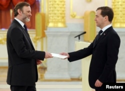 FILE - Russia's President Dmitry Medvedev, right, speaks with Tim Barrow, Britain's ambassador to Russia, during a ceremony in which newly appointed ambassadors present their credentials, in Moscow's Kremlin, Dec. 7, 2011.