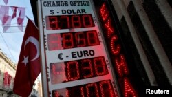 A board showing the currency exchange rates of the U.S. dollar and the Euro against Turkish lira is on display at a currency exchange office in Istanbul, Jan. 12, 2017.