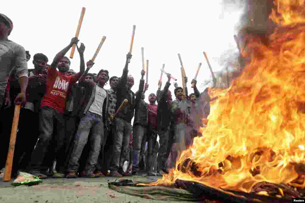 Activists of the Bangladesh Nationalist Party (BNP) shout slogans as they set fire to tyres during a nationwide blockade in Dhaka December 9, 2012. Police fired rubber bullets and tear gas to disperse protesters staging blockades across Bangladesh on Sund